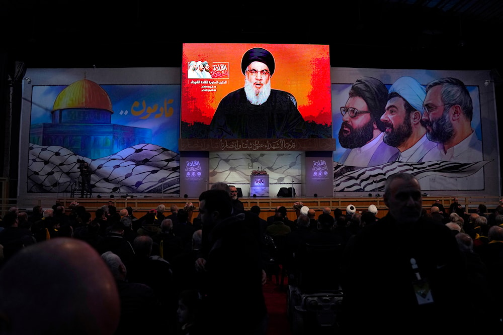Hezbollah Secretary-General Sayyed Hassan Nasrallah speaks on a screen via a video link during a ceremony to mark the anniversary of the martyrdom of Hezbollah leaders, in the southern suburbs of Beirut, Lebanon, February 16, 2024 (AP)