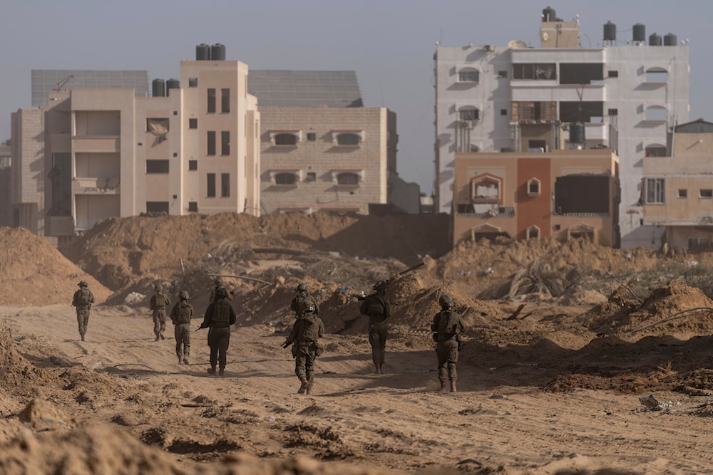 Israeli occupation forces walk during a ground operation in Khan Younis, Gaza Strip on Wednesday, Jan. 10. 2024(AP)