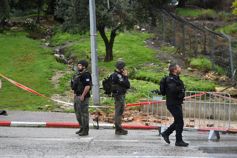 Israeli occupation forces examine the site hit by a rocket fired from Lebanon, in Safed, northern occupied Palestine, Wednesday, February 14, 2024 (AP)