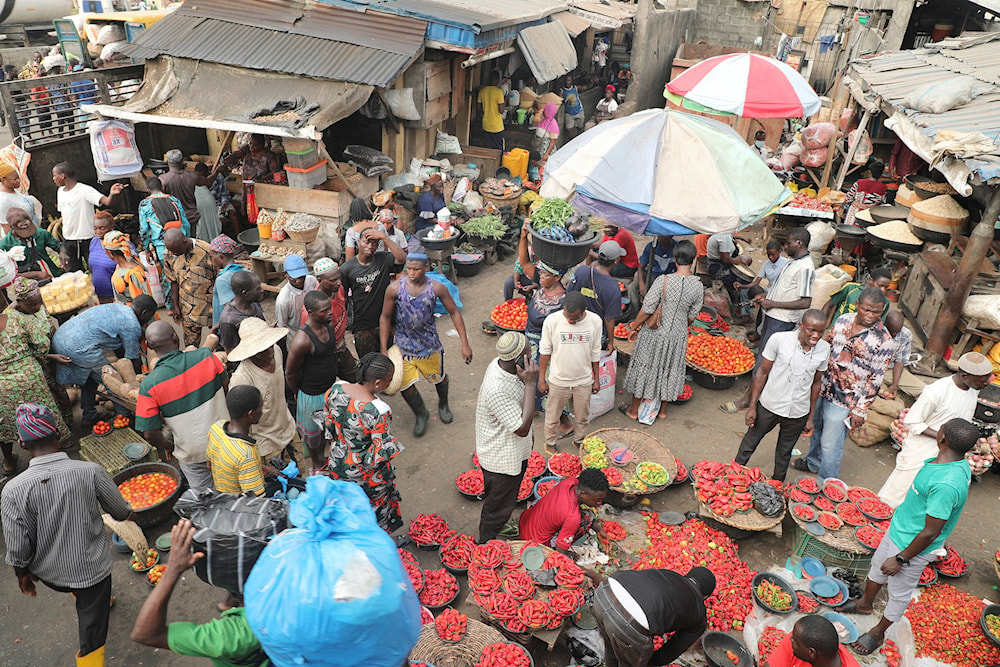 Pedestrians shop for pepper and other food items at the Mile 12 Market in Lagos, Nigeria, Friday, Feb. 16, 2024. (AP)