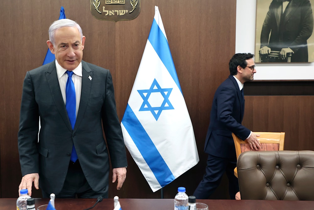 Israeli Prime Minister Benjamin Netanyahu, takes a seat before his meeting with France's Foreign Minister Stephane Sejourne, right, in occupied al-Quds, Monday, Feb. 5, 2024 (AP)