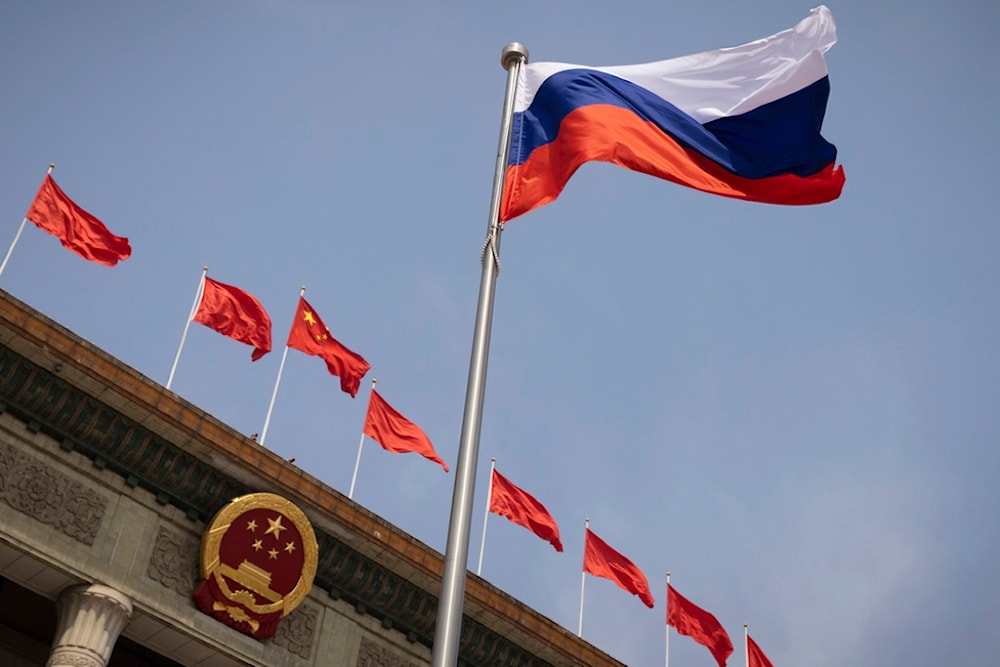 The Russian national flag flies in front of the Great Hall of the People before a welcoming ceremony for Russian Prime Minister Mikhail Mishustin in Beijing, China, Wednesday, May 24, 2023. (AP)