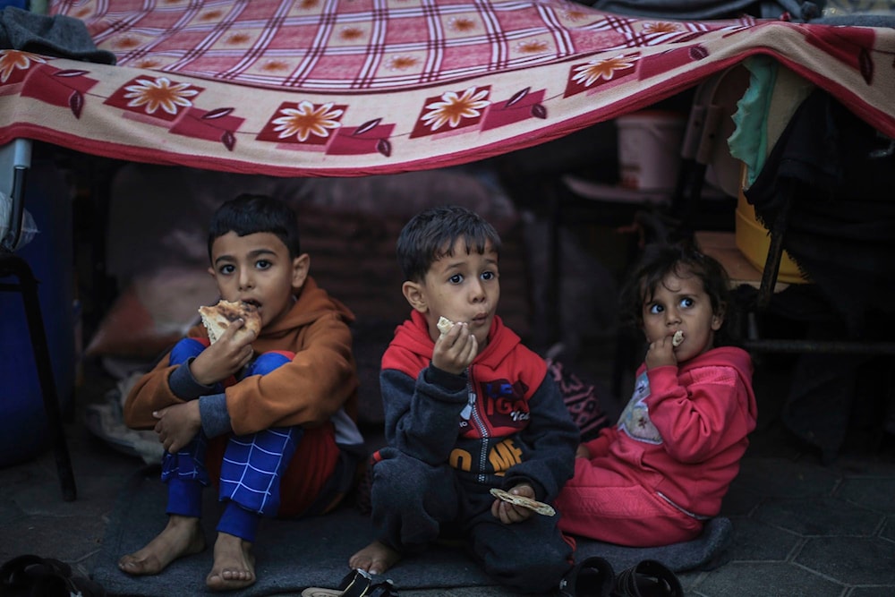 Palestinian children take shelter at a school run by the United Nations Relief and Works Agency for Palestine Refugees in the Near East (UNRWA), in Khan Yunis on November 15, 2023. (AP)