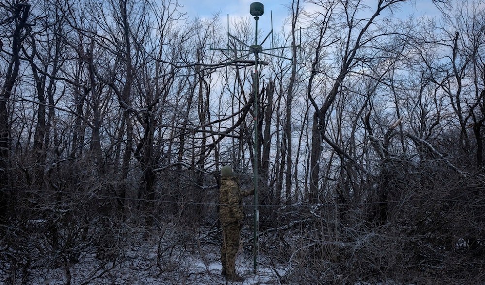A Ukrainian soldier installs an electronic warfare system antenna to listen to Russian chatter at the front line near Bakhmut, Donetsk region, Ukraine, Monday, Jan. 29, 2024. (AP)