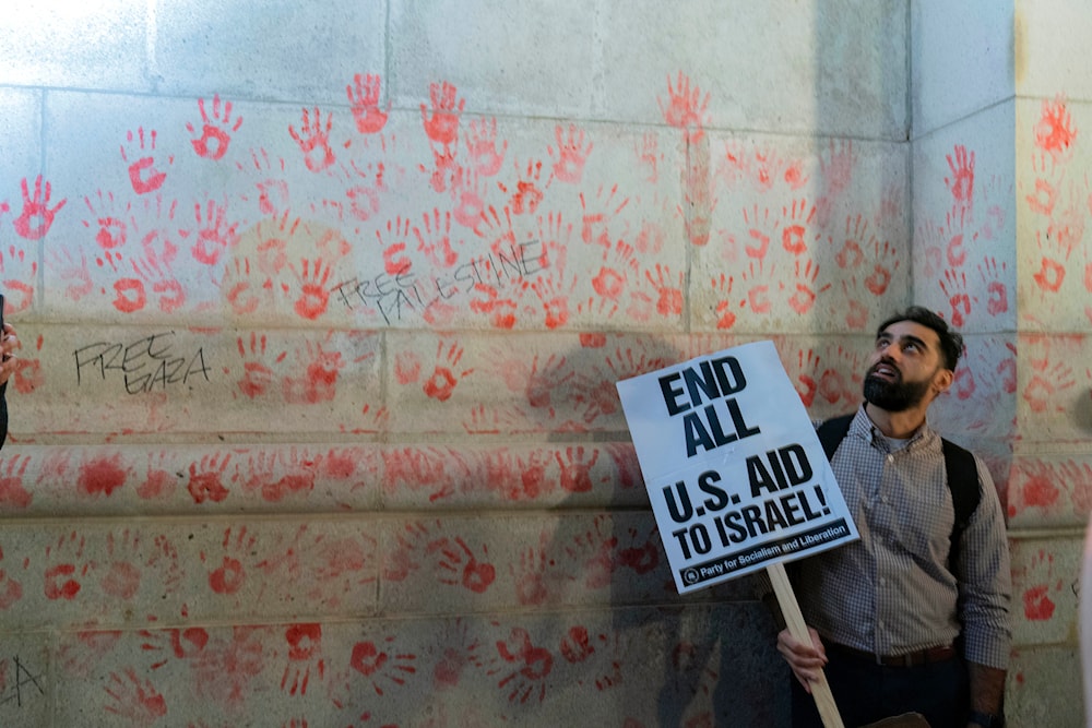 Handprints are seen on the wall of Union Station building as demonstrators protest during a pro-Palestinian rally asking for a cease-fire in Gaza, in Washington, Friday, Nov. 17, 2023(AP)