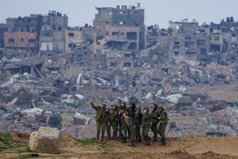 Israeli female soldiers pose for a photo on a position on the Gaza Strip 