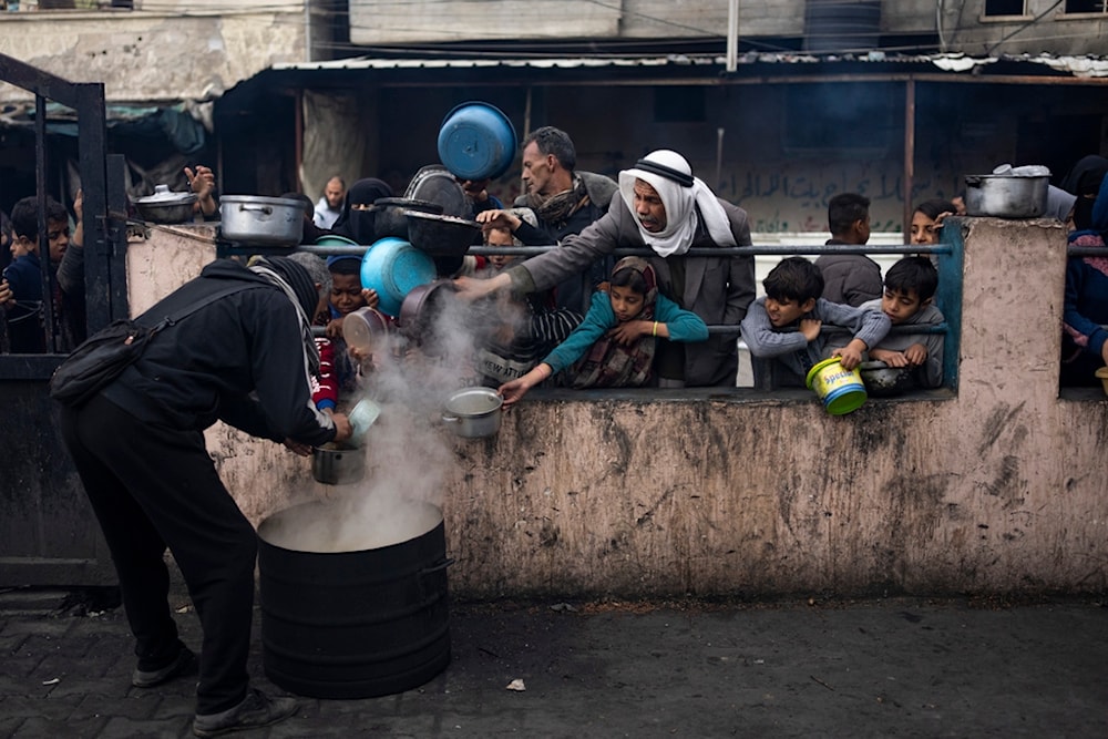 Palestinians line up for a meal in Rafah, Gaza Strip, Friday, Feb. 16, 2024. (AP)