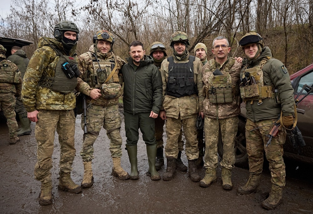 Ukrainian President Volodymyr Zelenskyy, center, poses for a photo with servicemen during his visit to Zaporizhzhia region, the site of fierce battles with the Russian troops, in Ukraine, Sunday, Feb. 4, 2024. (AP)