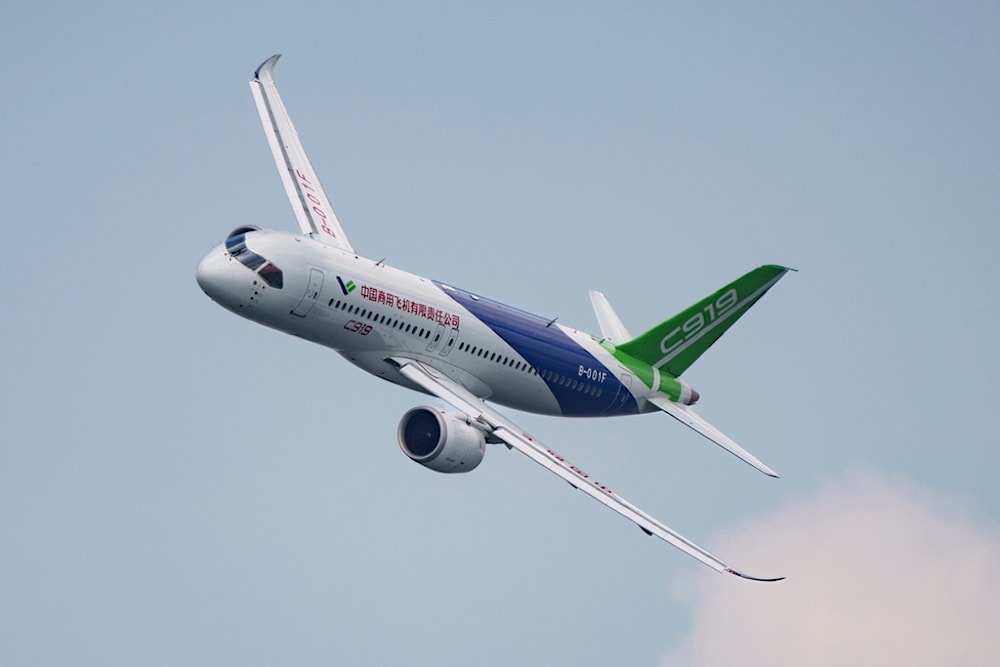 A China's COMAC C919 aircraft flies during the first day of the Singapore Airshow in Singapore, Tuesday, Feb. 20, 2024. (AP)