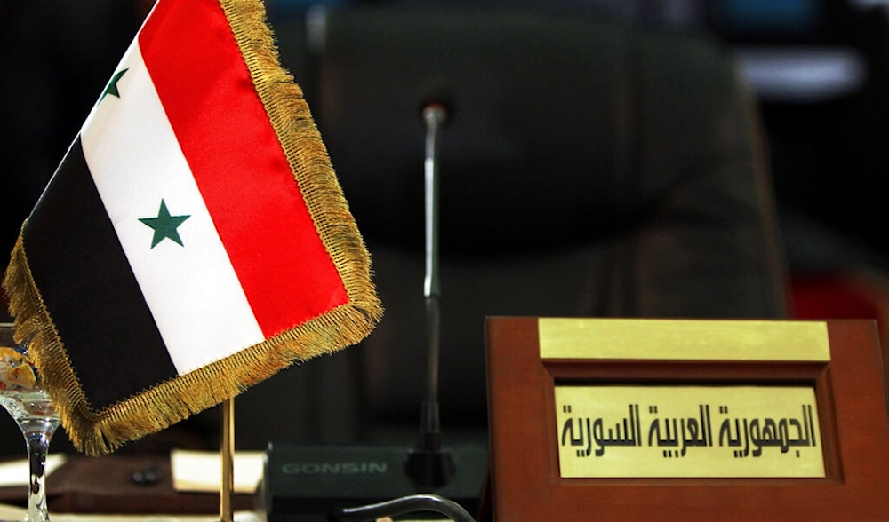The empty seat of the Syrian delegate is seen during the meeting of Arab economic, finance, and trade ministers as part of the Arab League Summit in Baghdad, Iraq, Tuesday, March 27, 2012. (AP)