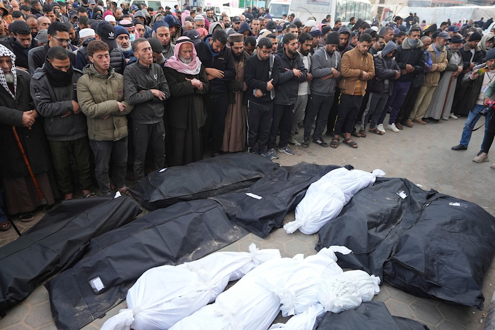 Palestinians pray over the bodies of their relatives martyred in the Israeli bombardments of the Gaza Strip in front of the morgue to pray over them at al-Aqsa Hospital in Deir al-Balah on Friday, Feb. 23, 2024. (AP)