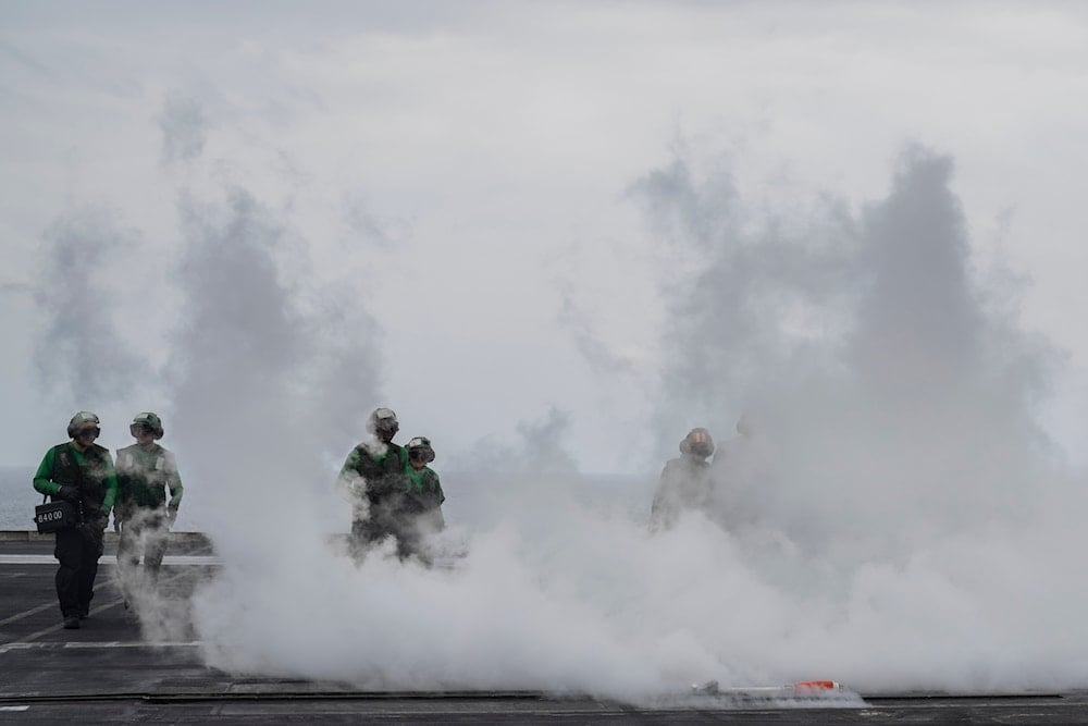 Crew walk the deck after takeoff of a fighter jet from the U.S.S. aircraft carrier Dwight D. Eisenhower, also known as the 'IKE', on the south Red Sea on Feb. 13, 2024. (AP)