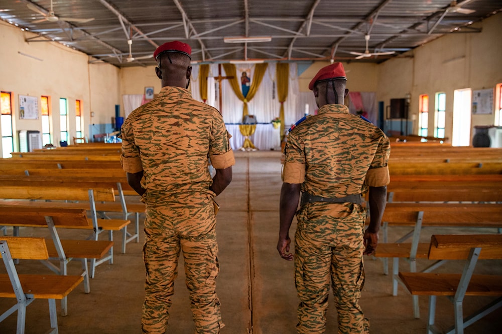 Two soldiers stand in the Catholic church at the 10th RCAS army barracks in Kaya, Burkina Faso, on Saturday, April 10, 2021.(AP)