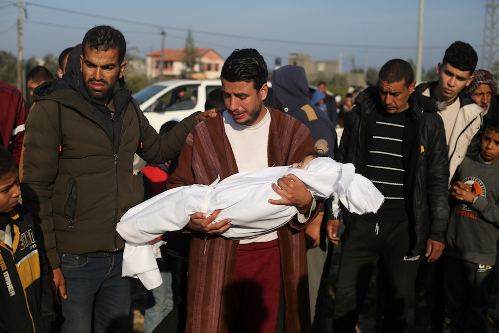 Palestinian Abdul Rahman Sharif holds the body of his four-year-old son Abdul Rahman Muamm, martyred by the Israeli bombardment of the Gaza Strip, during his funeral in Khan Younis, Monday, Feb. 26, 2024. (AP)
