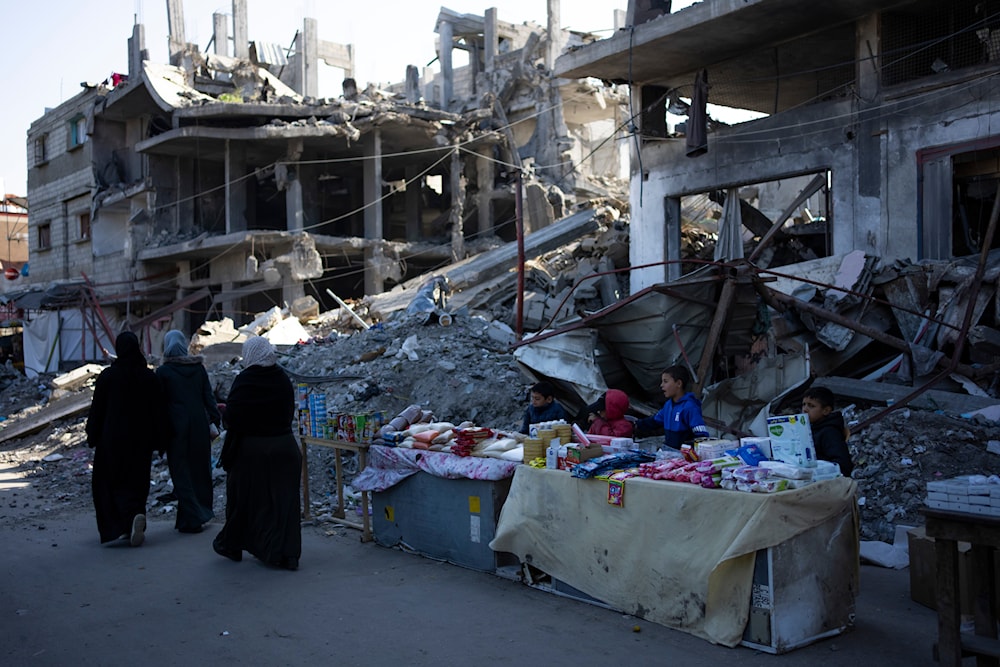 Palestinians sell goods next to buildings destroyed by an Israeli airstrike in Rafah, Gaza Strip, Wednesday, Feb. 21, 2024.(AP)