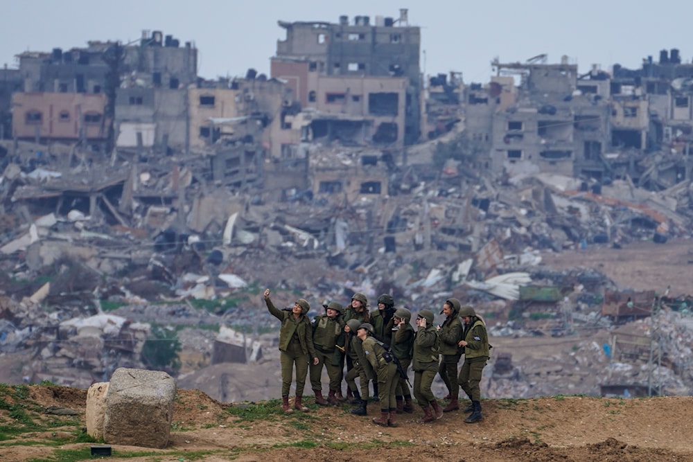 Israeli female soldiers pose for a photo on a position on the Gaza Strip border, in southern Israel, Monday, Feb. 19, 2024. (AP)