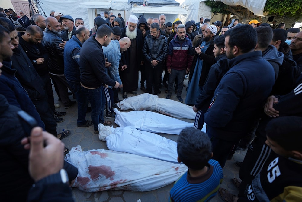 Palestinians mourn their relatives killed in the Israeli bombardments of the Gaza Strip in front of the morgue of the Al Aqsa Hospital in Deir al Balah, on Thursday, Feb. 29, 2024. (AP Photo)