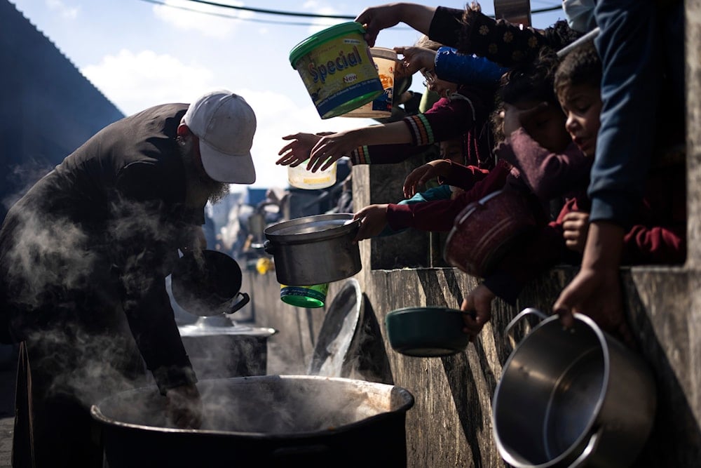 Palestinians line up for a free meal in Rafah, Gaza Strip, Friday, Feb. 16, 2024.(AP)