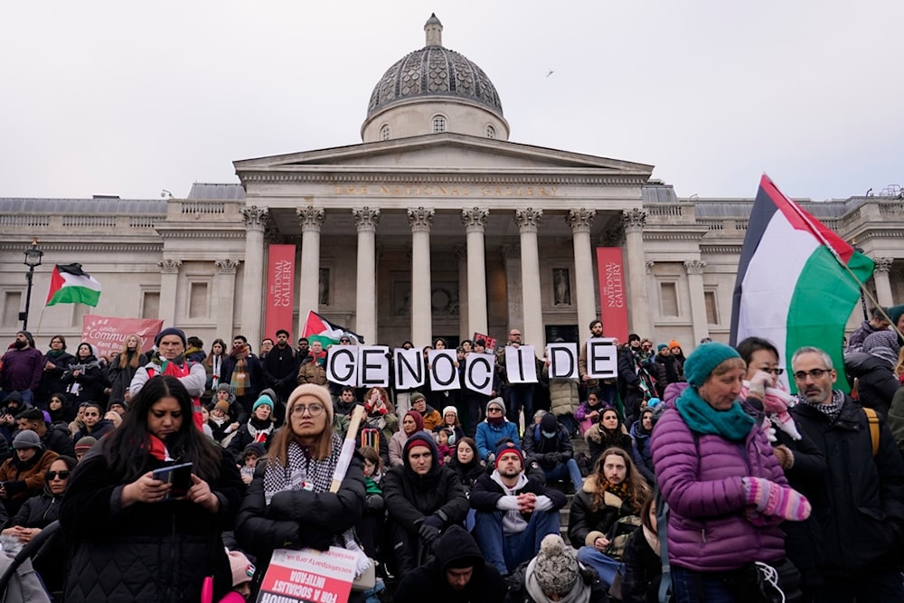 Protesters hold up banners, flags and placards in front of the national Gallery in Trafalgar Square during a demonstration in support of Palestinian people in Gaza, in London, Saturday, Jan. 13, 2024.(AP)