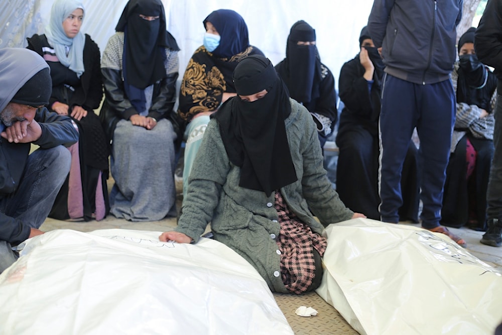 A Palestinian woman mourns relatives killed in the Israeli bombardment of the Gaza Strip in a morgue of the European Gaza Hospital in Khan Younis, Tuesday, Jan. 16, 2024. (AP)