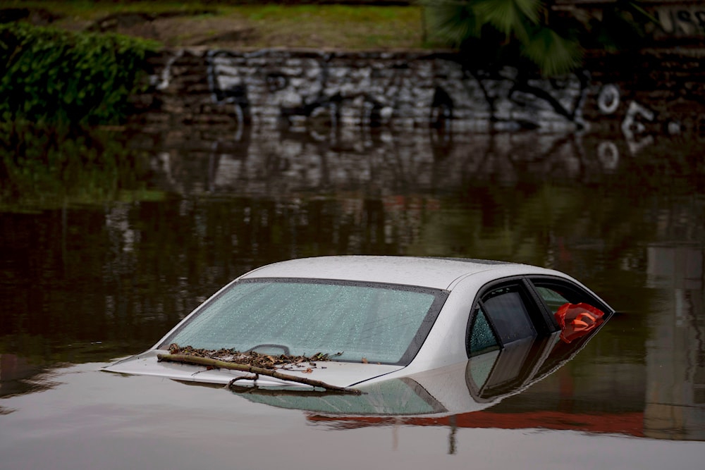 A car sits submerged on a flooded street under a railroad bridge, Thursday, Feb. 1, 2024 in Long Beach, California(AP)