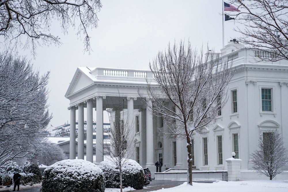 A worker removes snow from the White House driveway during a winter storm, Friday, January 19, 2024, in Washington. (AP)