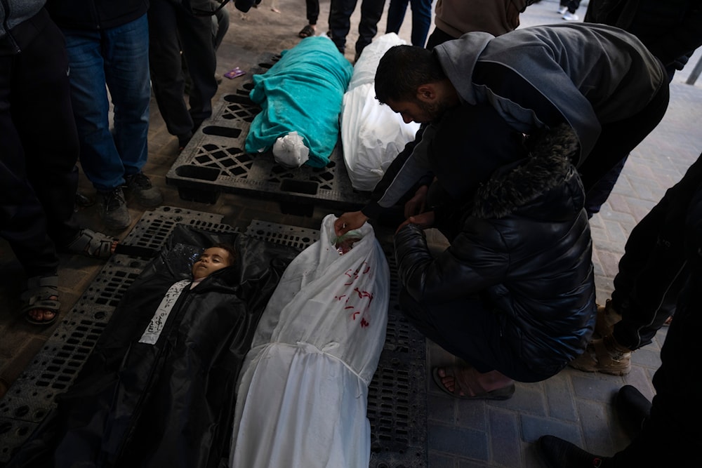 Palestinians mourn their relatives, including kids killed in the Israeli bombardment of the Gaza Strip, outside a morgue in Rafah, southern Gaza, Sunday, Feb. 4, 2024(AP)