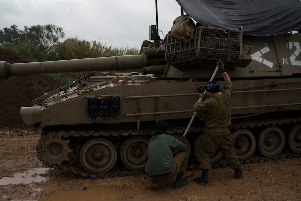 Israeli soldiers fix tracks near the border area between Lebanon and occupied Palestine, in northern Palestine, January 11, 2024 (AP)