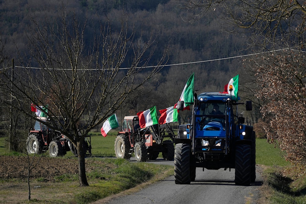 Manuele Calzoni, center, drives his tractor to join the protest of other farmers near the highway junction, in Orte, Italy, Saturday, Feb. 3, 2024(AP)