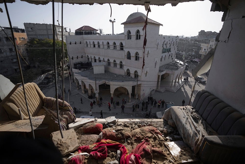 Palestinians look at a damaged residential building after an Israeli strike in Rafah, southern Gaza Strip, Wednesday, Jan. 10, 2024. (AP)