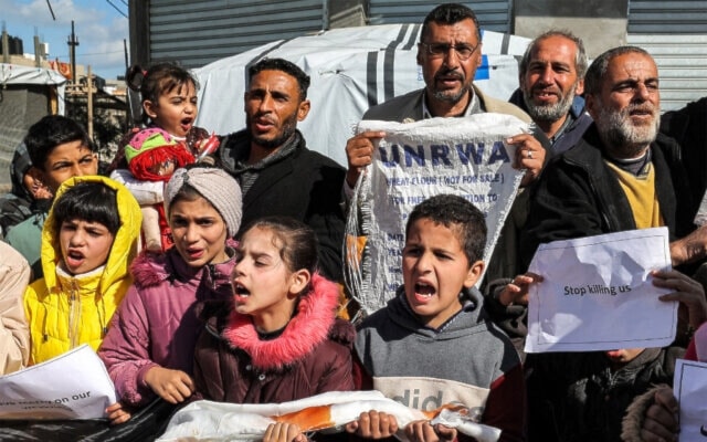 Palestinians demonstrate in Rafah in the southern Gaza Strip calling for continued international support to UNRWA, on January 30, 2024. (AFP)