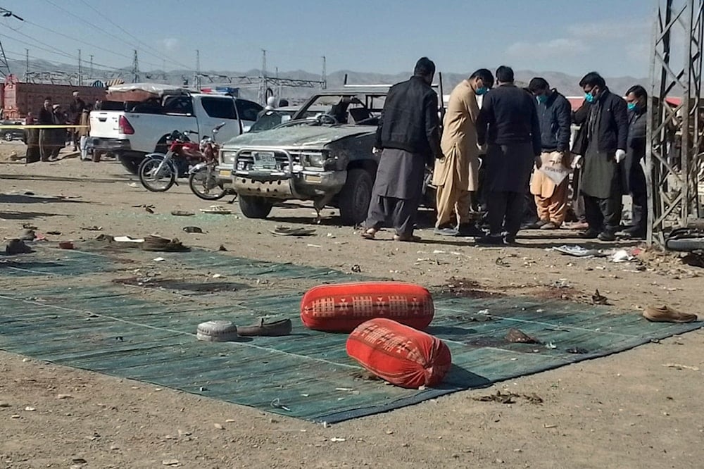 Security officials examine the scene of a bomb blast in Khanozai, Pashin, a district of Pakistan's Baluchistan province, Wednesday, Feb. 7, 2024. (AP)