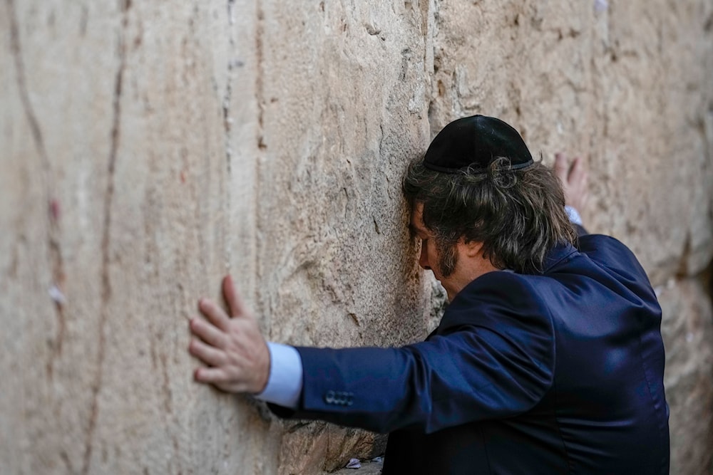 Argentine President Javier Milei touches the Western Wall, the holiest site where Jews can pray, in Jerusalem's Old City, Tuesday, Feb. 6, 2024. (AP)