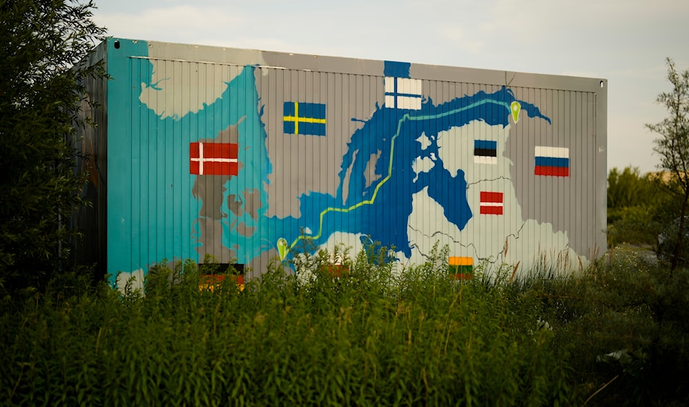 A painting showing the Nord Stream pipelines is displayed on a container near the Nord Stream 1 Baltic Sea pipeline in Lubmin, Germany, July 20, 2022. (AP)