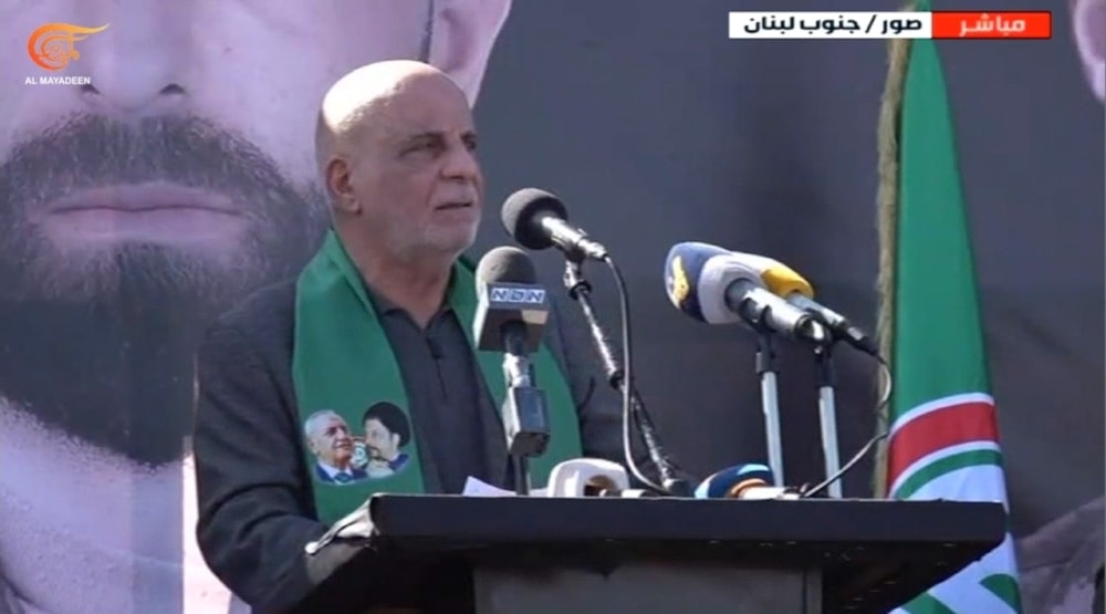 Member of the Lebanese Parliament, Ali Khreis, delivers his speech at the funeral of the martyrs of the Amal Movement on the Jerusalem Road in the city of Tyre, southern Lebanon. (ScreenGrab/Al Mayadeen Broadcast)