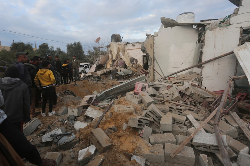Palestinians look at a residential house destroyed in an Israeli strike in Rafah, Gaza Strip, Monday, Feb. 5, 2024(AP)