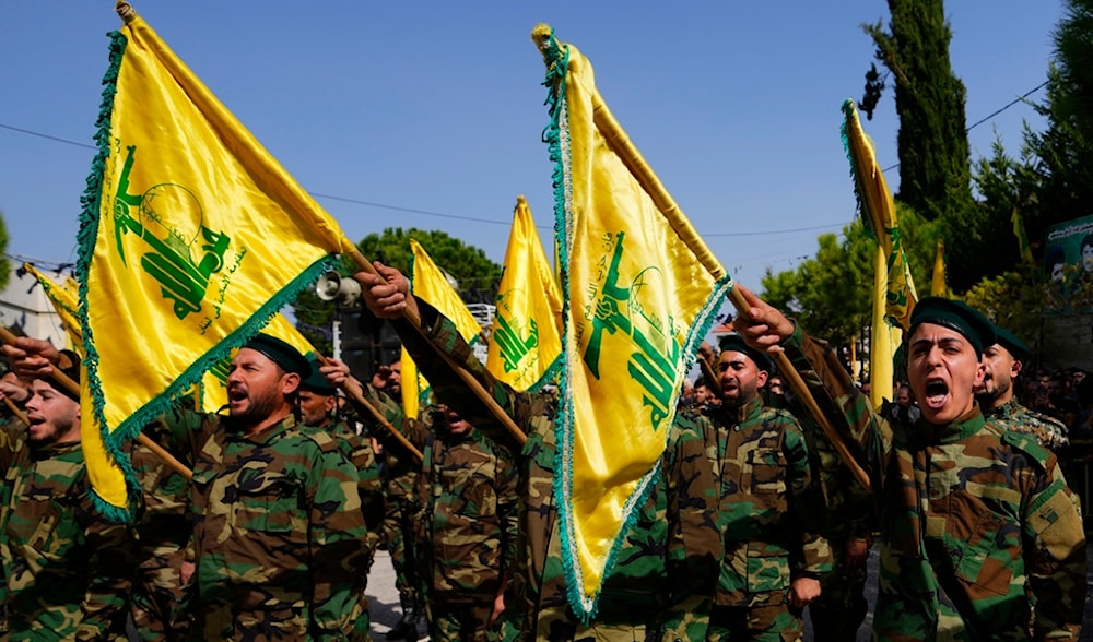 Hezbollah fighters rise their group's flag and shout slogans, during funeral processions in Majadel village, south Lebanon, Sunday, Oct. 22, 2023. (AP)