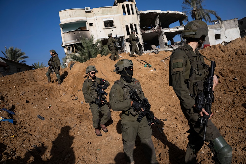 IOF troops are seen next to a destroyed building during a ground operation in Khan Younis, Gaza Strip, on Wednesday, Jan. 10. 2024(AP)