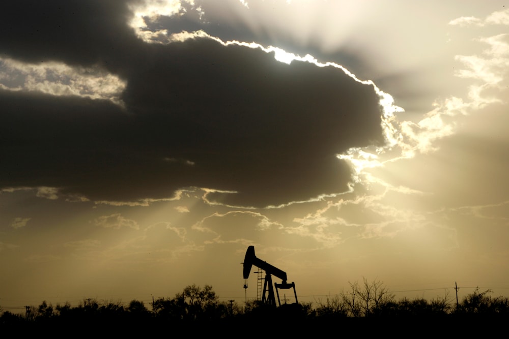 A pump jack is seen operating as clouds cover a setting sun in Lubbock, Texas, Wednesday, Nov. 11, 2006 (AP Photo/Tony Gutierrez)