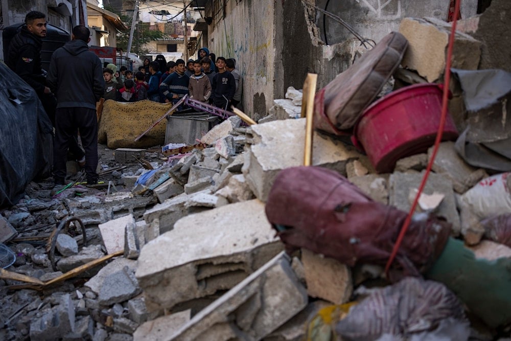 Palestinian kids look at the destruction after an Israeli strike in Rafah, southern Gaza Strip, Thursday, Feb. 8, 2024(AP)