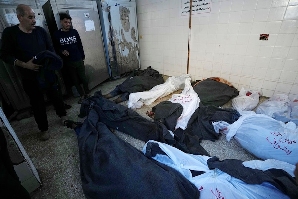 Palestinians look at the bodies of relatives killed in the Israeli bombardment of the Gaza Strip, inside a morgue of Al Aqsa hospital, in Deir al Balah, Gaza Strip, Tuesday, Feb. 6, 2024. (AP Photo)
