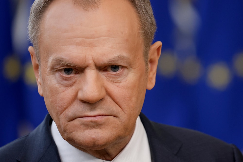 Poland's Prime Minister Donald Tusk listens to a question while talking to journalists as he arrives for an EU summit in Brussels, Thursday, Feb. 1, 2024.(AP)