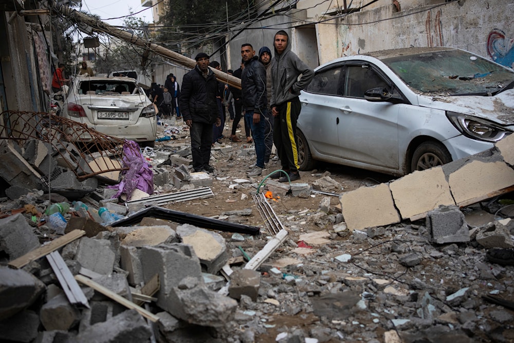 Palestinians look at the destruction after an Israeli airstrike in Rafah, Gaza Strip, February 9, 2024 (AP)