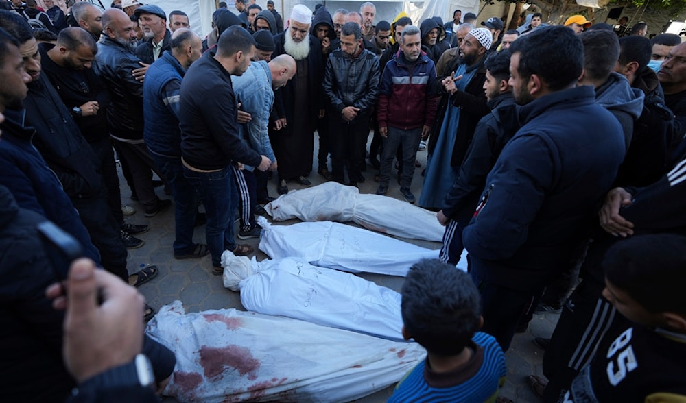 Palestinians mourn their relatives killed in the Israeli bombardments of the Gaza Strip in front of the morgue of the Al Aqsa Hospital in Deir al Balah, Gaza Strip, Palestine, on Thursday, Feb. 29, 2024. (AP)