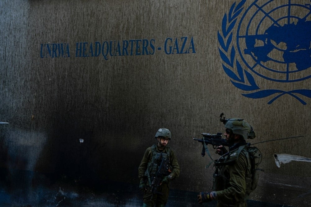 Israeli occupation forces take up positions as they raid the UNRWA headquarters in the Gaza Strip, on Thursday, February 8, 2024. (AP)