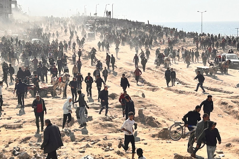 Palestinians wait for humanitarian aid on a beachfront in Gaza City, Gaza Strip, Palestine, Sunday, Feb. 25, 2024. (AP)