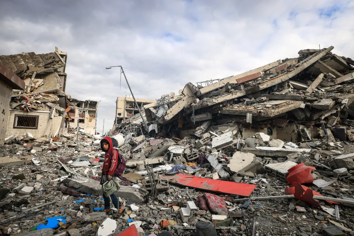 Palestinian child inspect the massive destruction caused by Israeli air raids on residential buildings in Wadi Gaza. (AFP)
