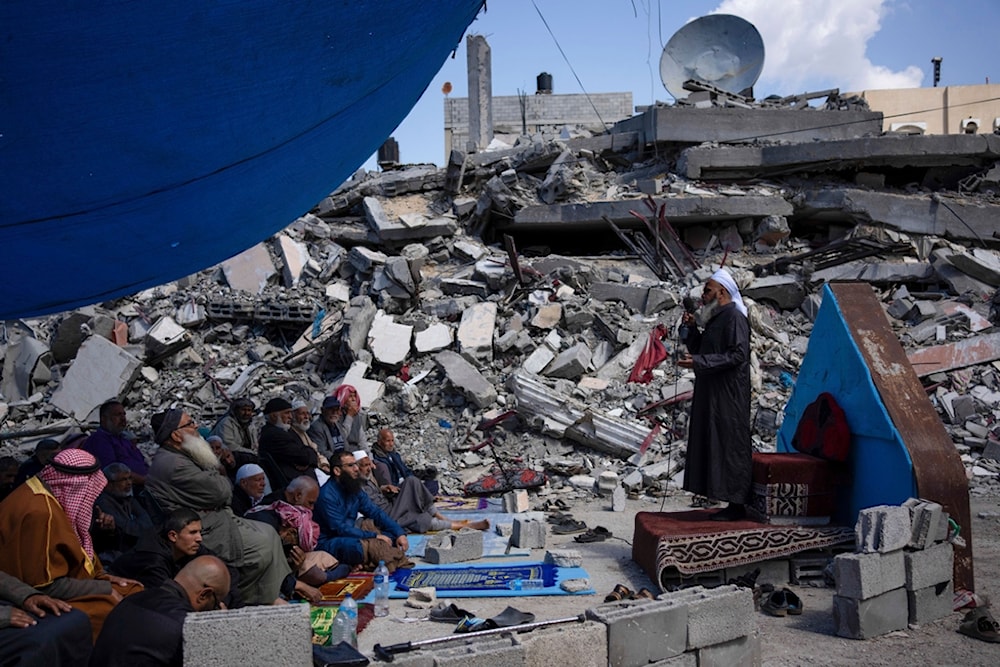 Palestinians pray in front of a mosque destroyed by the Israeli airstrikes in Rafah, Gaza Strip, Friday, March 8, 2024, ahead of the holy Islamic month of Ramadan. (AP Photo/Fatima Shbair)
