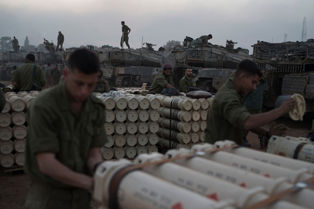 Israeli soldiers from the artillery unit store tank shells in a staging area at the Gaza border in southern occupied Palestine, Monday, Jan. 1, 2024. (AP)