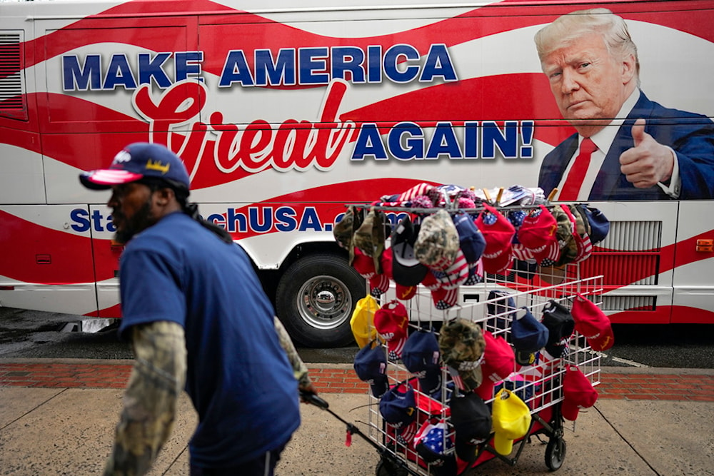 Vendors sell merchandise before Republican presidential candidate former President Donald Trump speaks at a campaign rally Saturday, March 9, 2024, in Rome Ga. (AP Photo/Mike Stewart)